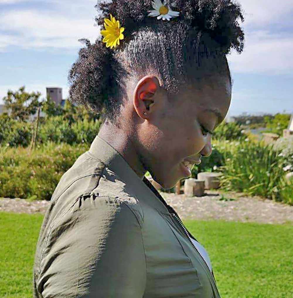 Outside picture showing an afro naturals lady treating afro hair at home