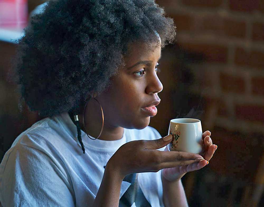 Woman drinking molasses tea the Healthy Natural Hair Growth product at Withthegoodhair or with the good hair or wtgh