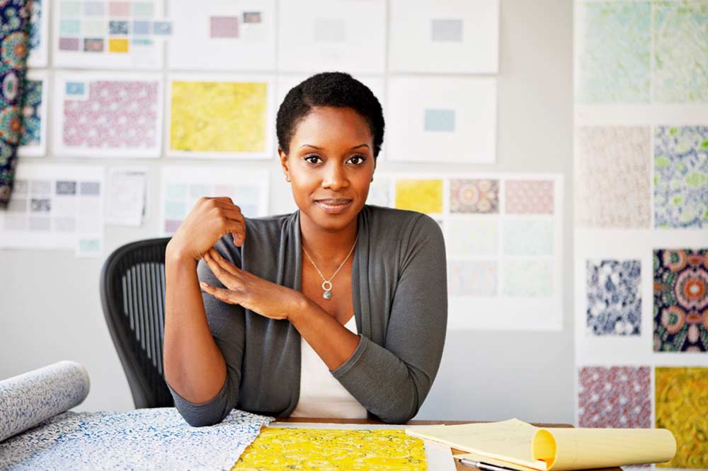 naturals lady sitting in her office with with low porosity hair at withthegoodhair