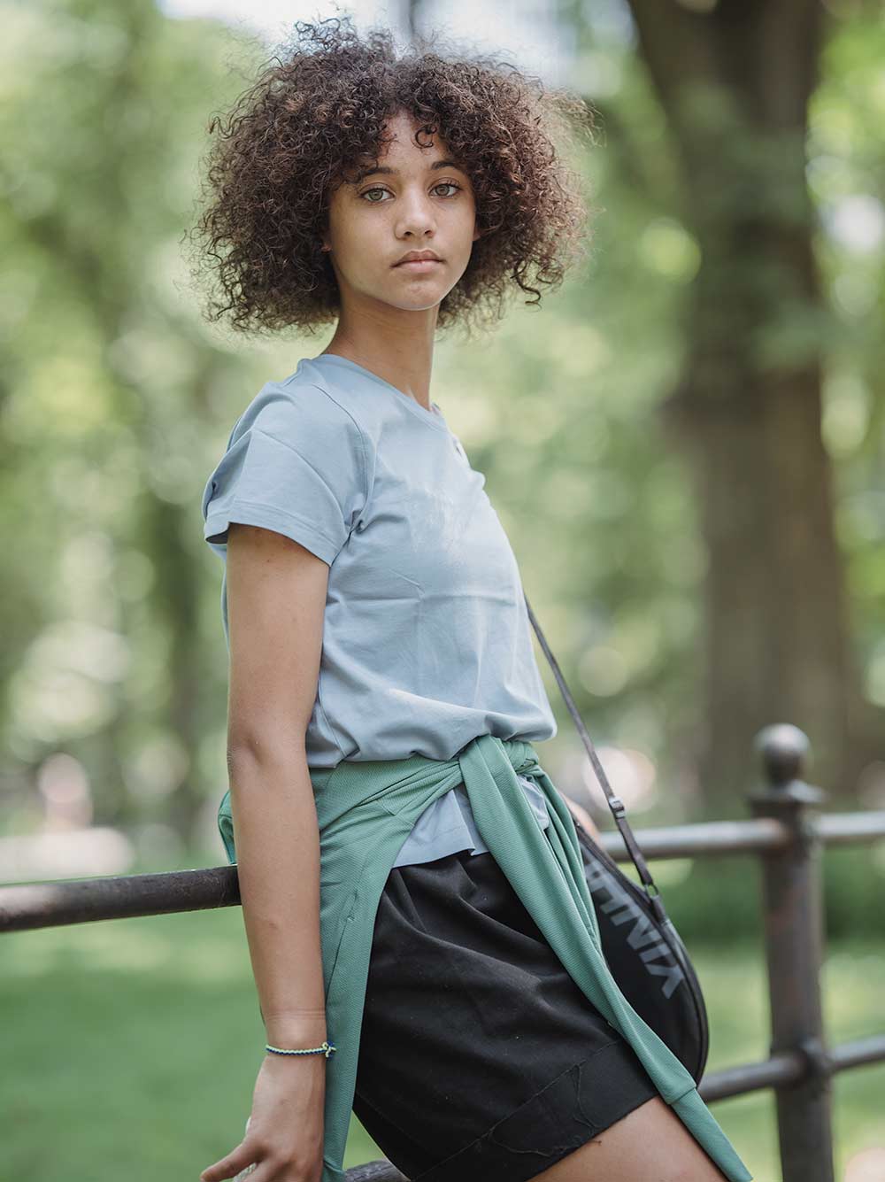 An African American lady standing outdoor with natural 3C hair type