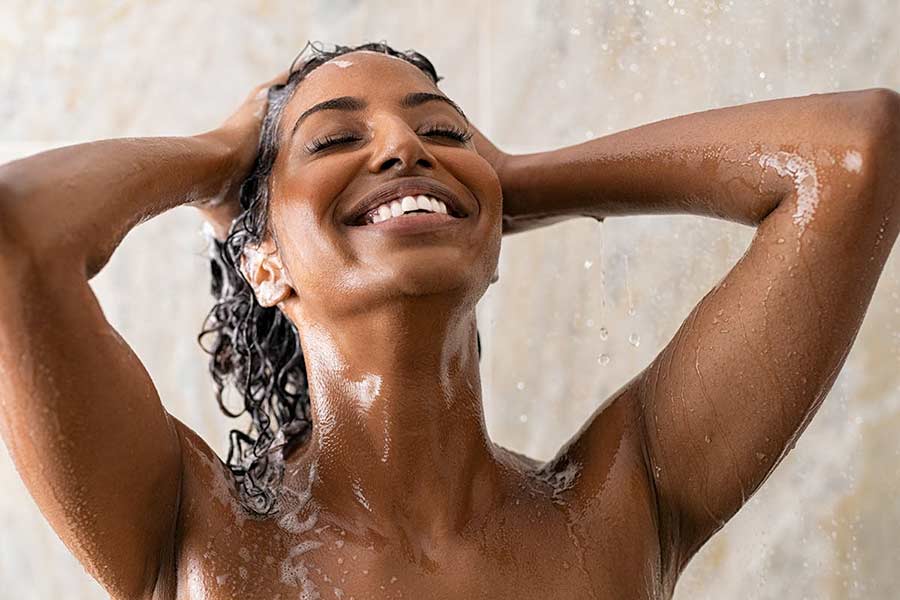 African lady with wet hair in the shower