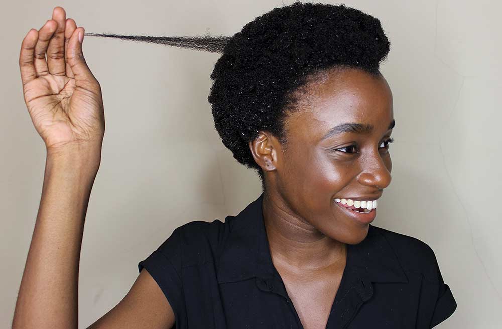lady showing off her natural 4c type hair
