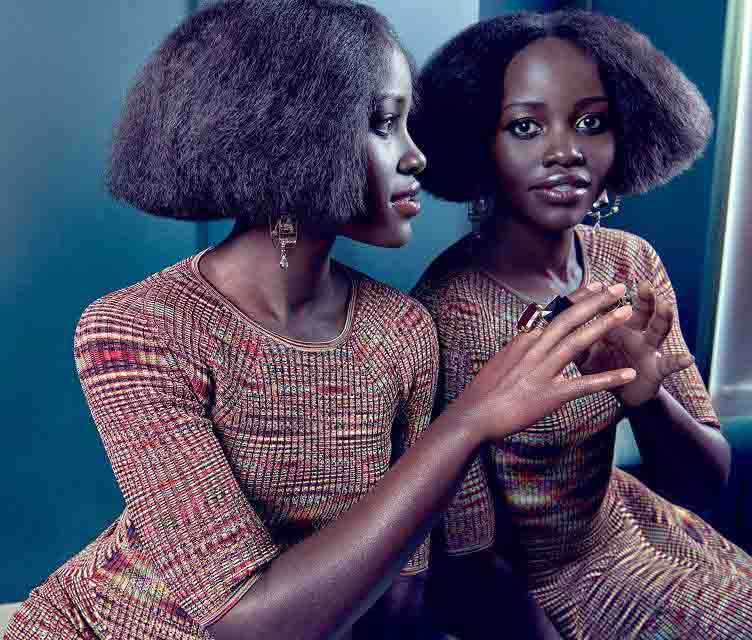 Woman with natural hair looking in mirror