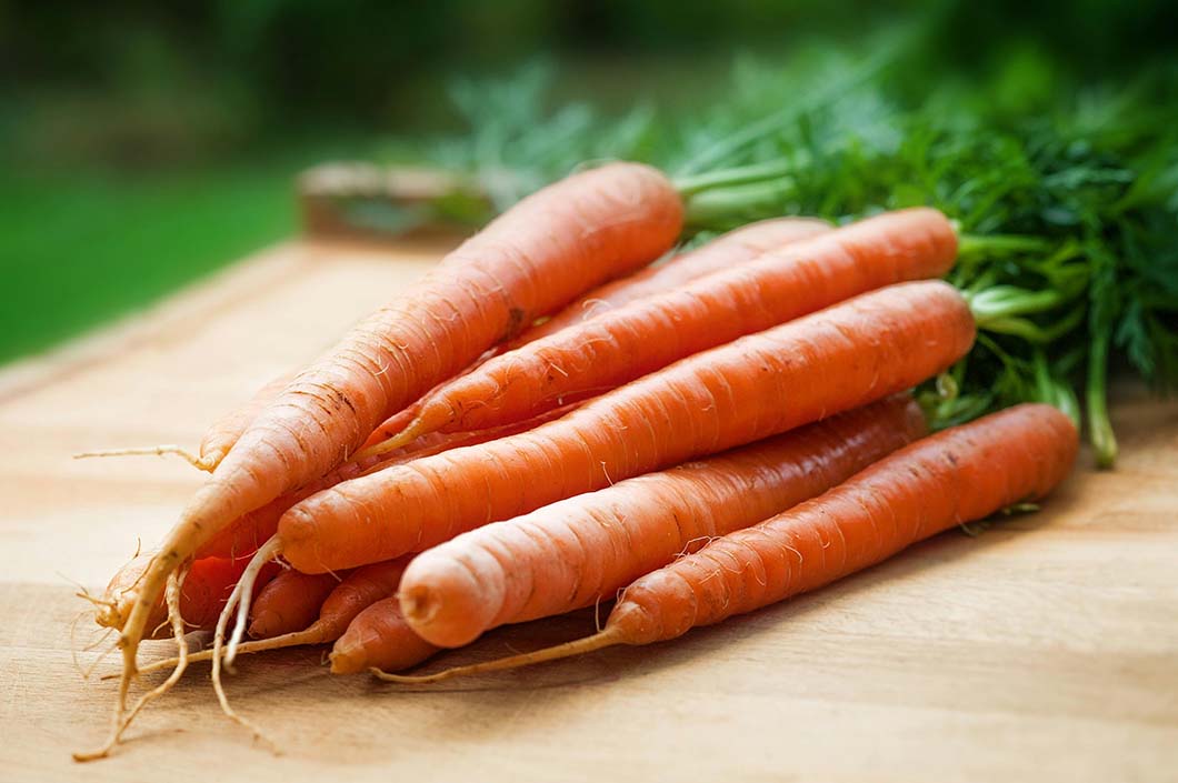 Carrots on a table showing that they are Iron-rich foods and can be eated with beetroots for hair growth