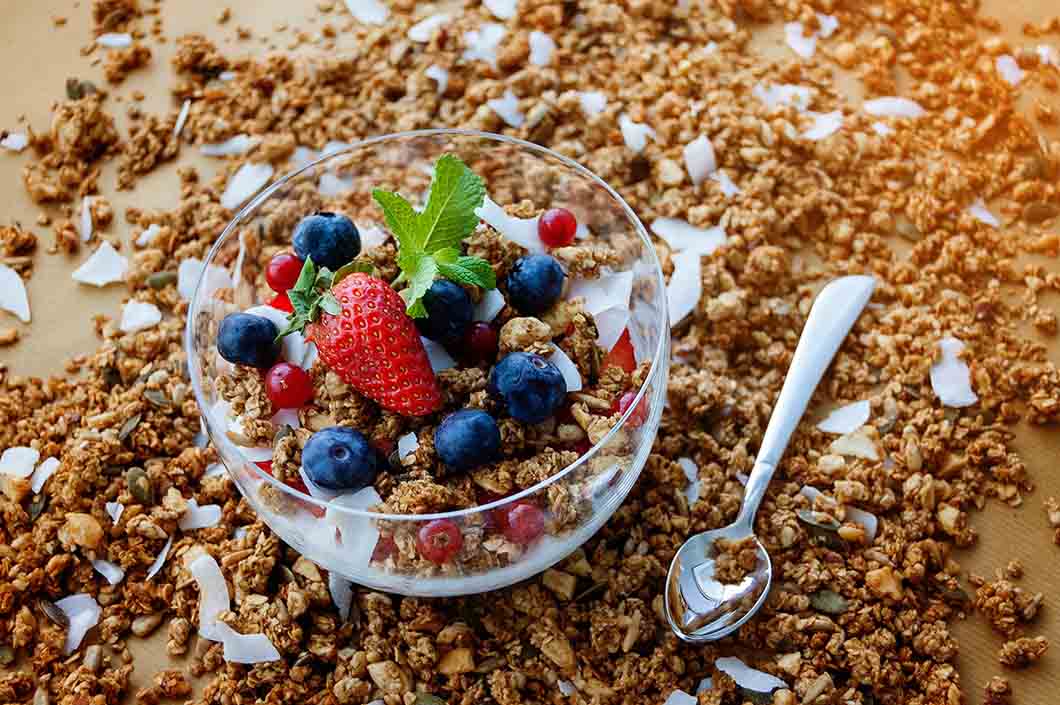Bowl of granola with berries on a table