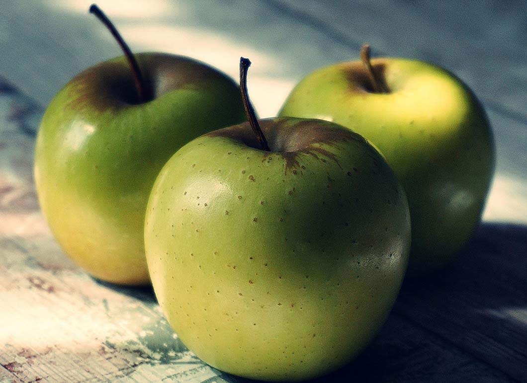 Three apples on a table