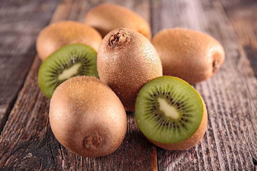 Kiwi fruit on a table as one of the 17 superfoods that can help combat hair loss