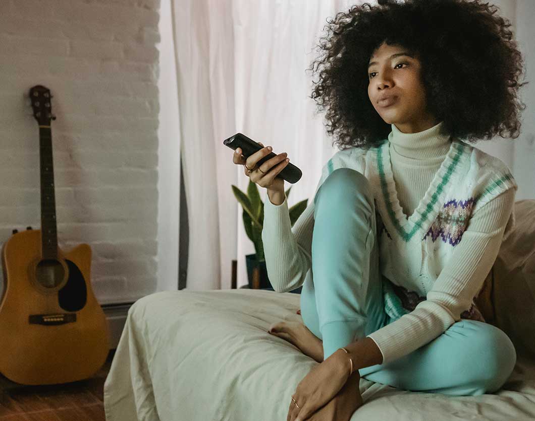 Girl with afro sitting on a chair