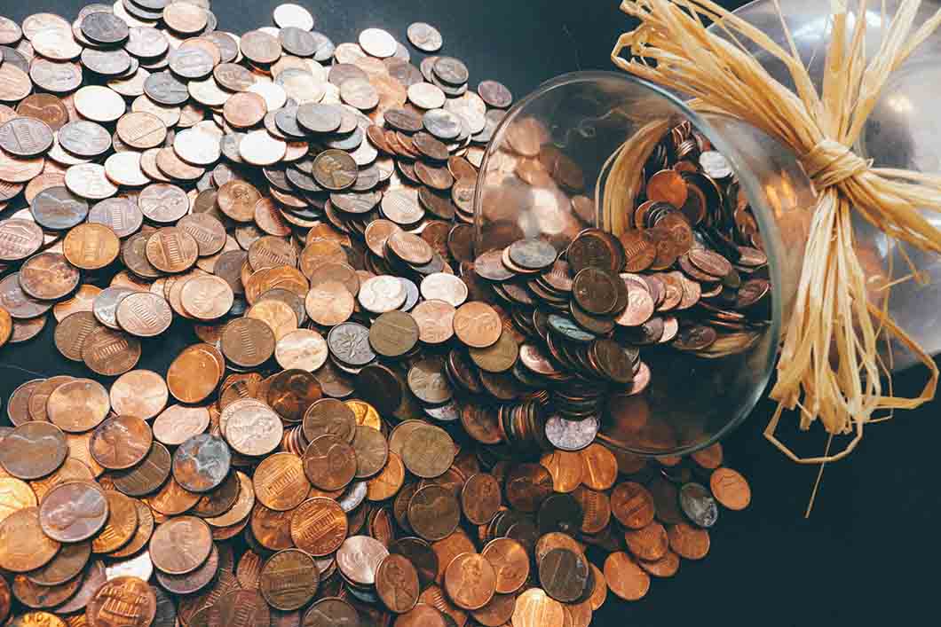 Coins spilling out of a jar