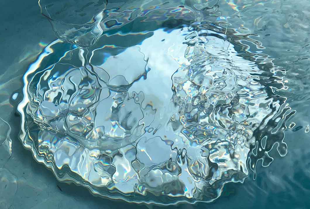 A puddle of water to show water test for synthetic wigs