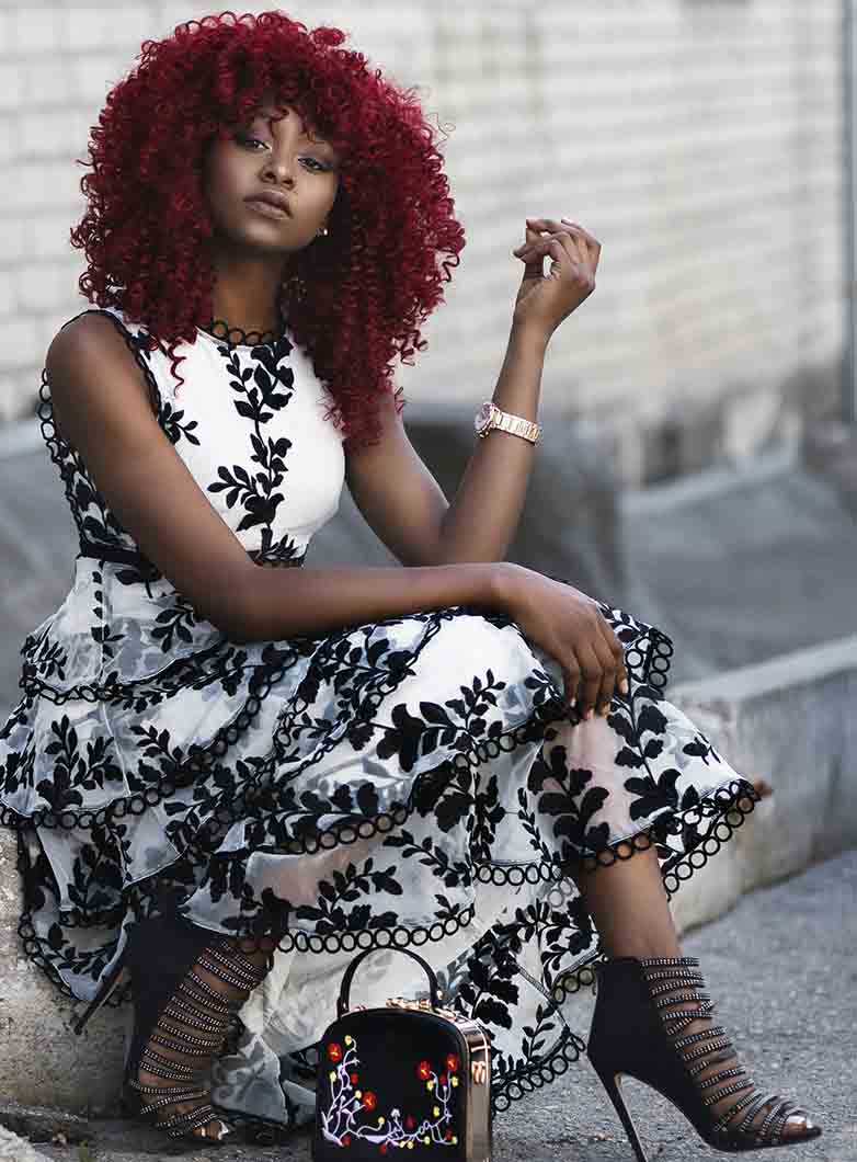 African woman in red, curly wig