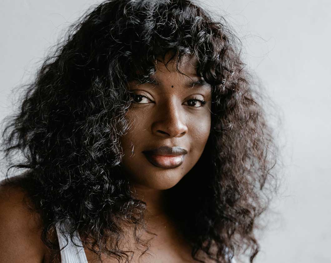 Black female with textured, curly wig 