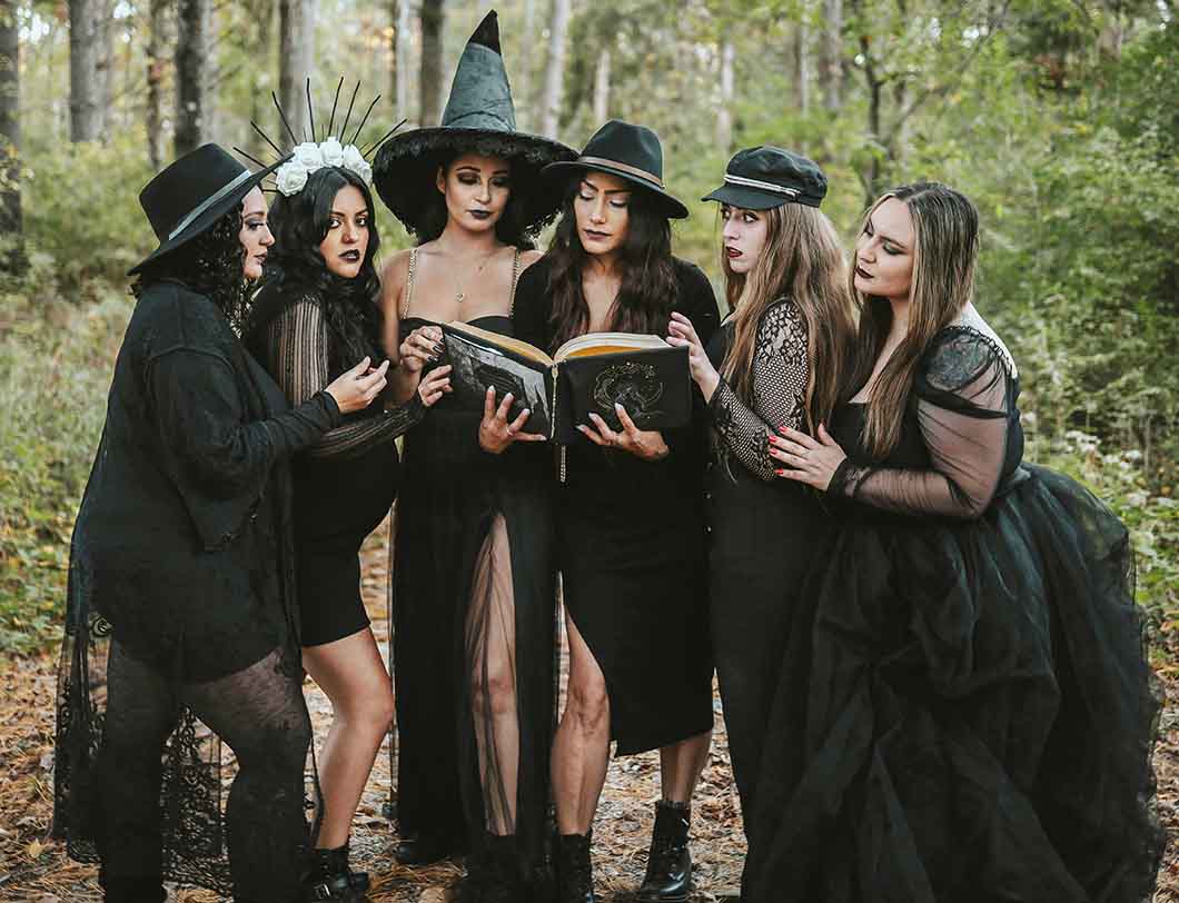 Women in witch costumes and pointy hats