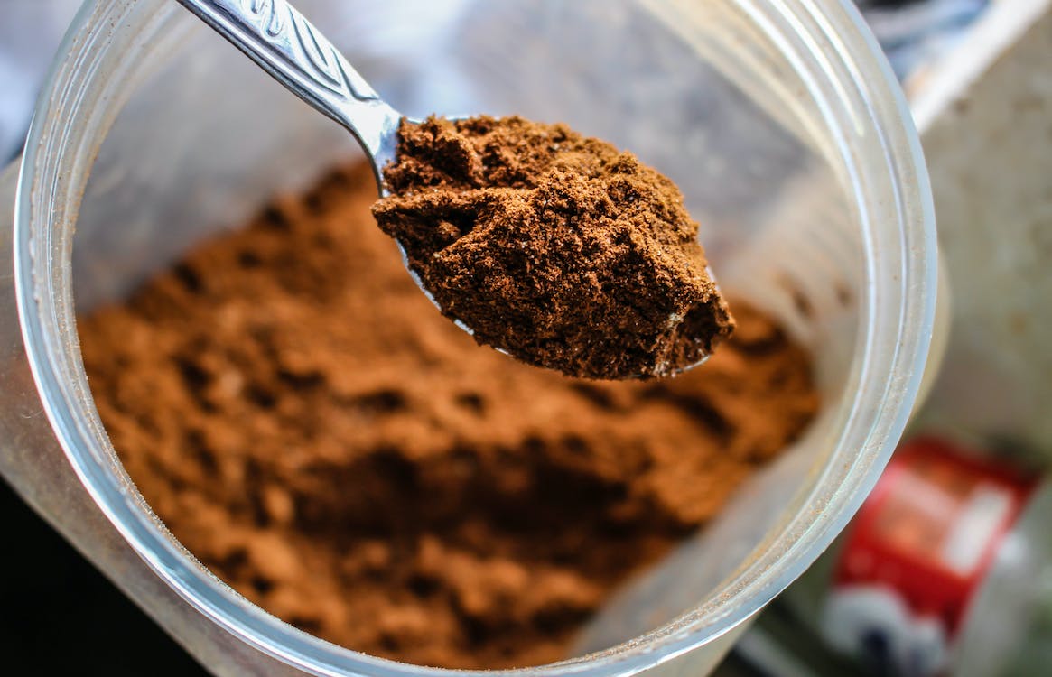 A spoon of chebe powder showing how DIY chebe butter can strengthen your hair strands.