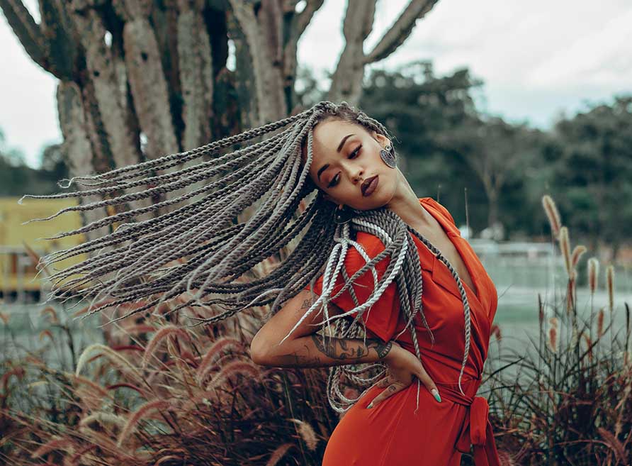 Woman in braids showing the do's and dont's for protective styling