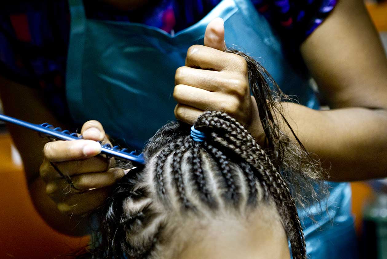 Woman braiding natural hair in mombasa