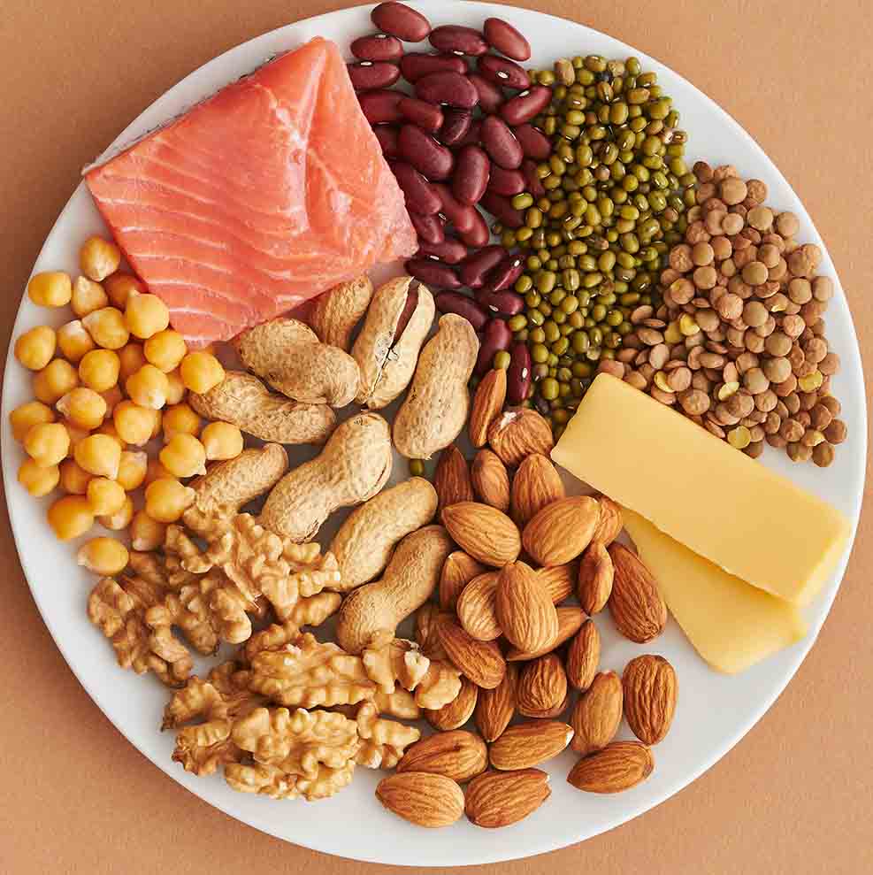 Foods rich in Iron that promote hair growth lined onto a large, white plate