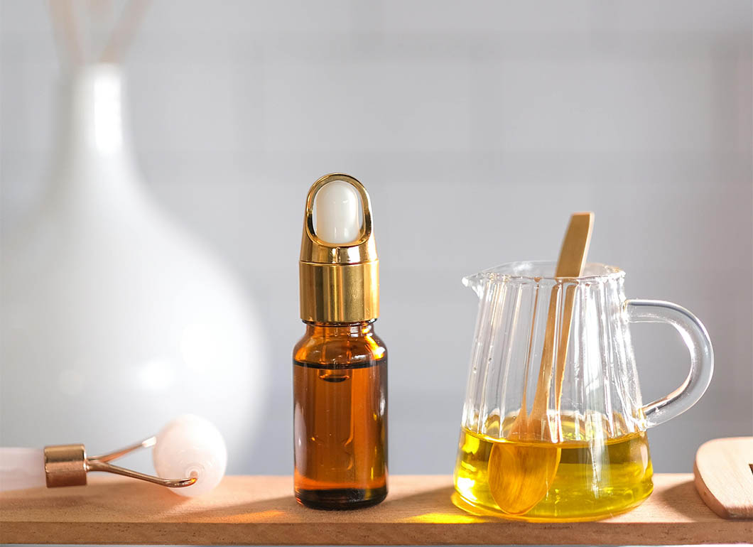 Onion oil for hair growth on a wooden cutting board